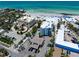 An aerial view showcases beachfront condos with pool, parking and Gulf Coast beaches at 1001 Point Of Rocks Rd # 207, Sarasota, FL 34242