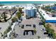 Aerial view of a beachside property with parking, a pool, and access to a sandy beach at 1001 Point Of Rocks Rd # 207, Sarasota, FL 34242