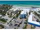 Stunning aerial view of beachfront property with white sand beach and beautiful clear, blue water at 1001 Point Of Rocks Rd # 207, Sarasota, FL 34242