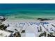 Expansive aerial view of the pristine beach and turquoise ocean, complete with beach umbrellas and soft white sand at 1001 Point Of Rocks Rd # 207, Sarasota, FL 34242