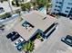 Aerial view of a two-story building with unique courtyard seating and ample parking at 1001 Point Of Rocks Rd # 207, Sarasota, FL 34242