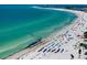 A picturesque beach featuring white sand, turquoise water, and colorful umbrellas on a sunny day at 1001 Point Of Rocks Rd # 207, Sarasota, FL 34242