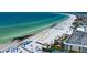 A vast shoreline showcases beachgoers, white sand, and turquoise waters on a sunny day at 1001 Point Of Rocks Rd # 207, Sarasota, FL 34242