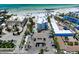 Overhead view of beachside condos with palm trees, parking, pool and Gulf Coast beaches at 1001 Point Of Rocks Rd # 207, Sarasota, FL 34242