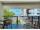 Balcony view of the ocean, pool, and palm trees, providing a serene and picturesque outdoor retreat at 1001 Point Of Rocks Rd # 207, Sarasota, FL 34242