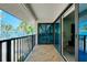 Large, sunny balcony with sliding glass doors and views of palms at 1001 Point Of Rocks Rd # 207, Sarasota, FL 34242