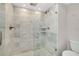Modern bathroom shower with marble tiles and a built-in shelf for toiletries creates a spa-like experience at 1001 Point Of Rocks Rd # 207, Sarasota, FL 34242