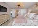 A bedroom featuring a ceiling fan, a large TV, and a doorway to the kitchen at 1001 Point Of Rocks Rd # 207, Sarasota, FL 34242