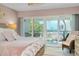 Beach-themed bedroom with balcony access and ocean views at 1001 Point Of Rocks Rd # 207, Sarasota, FL 34242