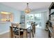 The dining area boasts an ocean-inspired chandelier, slider access to a patio and pass-through to the kitchen at 1001 Point Of Rocks Rd # 207, Sarasota, FL 34242