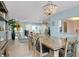 The dining room features modern decor, patio access, kitchen pass-through and stair access to the upstairs living area at 1001 Point Of Rocks Rd # 207, Sarasota, FL 34242