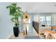 Hallway features a potted palm tree, stairs and views into living space at 1001 Point Of Rocks Rd # 207, Sarasota, FL 34242