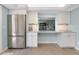 Open kitchen with stainless steel appliances and a breakfast bar connecting to the living area at 1001 Point Of Rocks Rd # 207, Sarasota, FL 34242