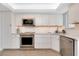 Well-equipped kitchen featuring stainless steel appliances, marble countertops, and custom cabinetry at 1001 Point Of Rocks Rd # 207, Sarasota, FL 34242