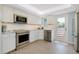 Modern kitchen with stainless steel appliances, light countertops, and access to the balcony at 1001 Point Of Rocks Rd # 207, Sarasota, FL 34242