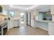Bright kitchen with stainless steel appliances, white cabinets and access to the balcony at 1001 Point Of Rocks Rd # 207, Sarasota, FL 34242