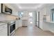 Bright kitchen with stainless steel appliances, white cabinets and access to the balcony at 1001 Point Of Rocks Rd # 207, Sarasota, FL 34242