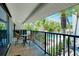 Relaxing lanai with comfortable seating overlooks a sparkling pool and lush tropical landscaping at 1001 Point Of Rocks Rd # 207, Sarasota, FL 34242