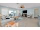 Bright living room featuring tile floors, contemporary furnishings, and sliding doors to an outdoor area at 1001 Point Of Rocks Rd # 207, Sarasota, FL 34242