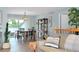 Light and airy living room with dining area, stylish furnishings, and balcony access at 1001 Point Of Rocks Rd # 207, Sarasota, FL 34242