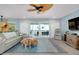 Relaxing living room with large sectional sofa and views to balcony at 1001 Point Of Rocks Rd # 207, Sarasota, FL 34242