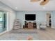 Cozy living room with light blue walls, a rustic TV stand, unique decor, and a coastal vibe at 1001 Point Of Rocks Rd # 207, Sarasota, FL 34242