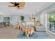 Spacious living room with comfortable seating, artistic coffee tables, with view to the outdoor patio and dining area at 1001 Point Of Rocks Rd # 207, Sarasota, FL 34242