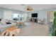 Bright living room featuring tile floors, contemporary furnishings, and sliding doors to an outdoor area at 1001 Point Of Rocks Rd # 207, Sarasota, FL 34242
