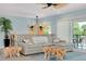 Cozy living room with views, ceiling fans and unique wooden furniture, creating a relaxed, coastal ambiance at 1001 Point Of Rocks Rd # 207, Sarasota, FL 34242