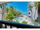 Beautiful view of pool surrounded by palm trees providing a luxurious outdoor setting for relaxation at 1001 Point Of Rocks Rd # 207, Sarasota, FL 34242