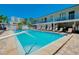 Well maintained pool with lounge chairs, white picket fence and access to rooms at 1001 Point Of Rocks Rd # 207, Sarasota, FL 34242