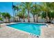 Well maintained pool surrounded by lush landscaping, dining and seating areas at 1001 Point Of Rocks Rd # 207, Sarasota, FL 34242