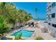 The pool deck offers plenty of lounge chairs, a gazebo, and lush tropical landscaping at 1001 Point Of Rocks Rd # 207, Sarasota, FL 34242