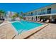 Well maintained pool with lounge chairs, white picket fence and access to rooms at 1001 Point Of Rocks Rd # 207, Sarasota, FL 34242