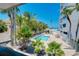 Scenic view of the pool surrounded by lush palm trees and seating, perfect for relaxation at 1001 Point Of Rocks Rd # 207, Sarasota, FL 34242