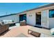 Relaxing rooftop deck with furniture, palm tree views, and a sunny blue sky at 1001 Point Of Rocks Rd # 207, Sarasota, FL 34242