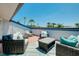 Relaxing rooftop deck features comfortable seating, palm trees, and a sunny sky at 1001 Point Of Rocks Rd # 207, Sarasota, FL 34242