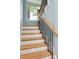 Staircase features wood treads and wrought iron spindles at 1001 Point Of Rocks Rd # 207, Sarasota, FL 34242