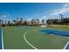 Full-sized basketball court with blue and green accents provides a recreational space for sports enthusiasts at 11502 Golden Bay Pl, Bradenton, FL 34211
