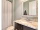 Bathroom featuring a granite vanity and a framed mirror, complete with a shower-tub with shower curtain at 11502 Golden Bay Pl, Bradenton, FL 34211