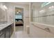 Modern bathroom with a glass-enclosed shower and granite countertop vanity, offering a luxurious and functional space at 11502 Golden Bay Pl, Bradenton, FL 34211
