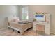 Well-lit bedroom with makeup vanity, offering a peaceful retreat and a personal touch at 11502 Golden Bay Pl, Bradenton, FL 34211