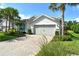 Lovely single-story home features a tile roof, two-car garage, paver driveway, and lush tropical landscaping at 11502 Golden Bay Pl, Bradenton, FL 34211