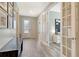 Beautiful foyer with wood-look tile flooring, leading to an office with french doors at 11502 Golden Bay Pl, Bradenton, FL 34211