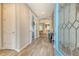 Bright and airy foyer with wood-look tile flooring, archways, and a decorative glass front door at 11502 Golden Bay Pl, Bradenton, FL 34211