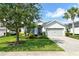 Charming single-story home with a well-manicured lawn, beautiful landscaping, and a paver driveway at 11502 Golden Bay Pl, Bradenton, FL 34211