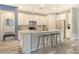 Bright kitchen with white cabinets, stainless steel appliances, granite countertops, and a stylish island with seating at 11502 Golden Bay Pl, Bradenton, FL 34211