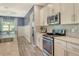 Stylish kitchen showcasing stainless steel oven and microwave, granite countertops, and ample white cabinet storage at 11502 Golden Bay Pl, Bradenton, FL 34211
