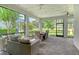 Spacious screened lanai with wicker sofa, brick pavers, and outdoor dining area with backyard views at 11502 Golden Bay Pl, Bradenton, FL 34211
