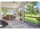 Screened lanai with brick flooring, ceiling fan, and outdoor seating for enjoying the backyard view at 11502 Golden Bay Pl, Bradenton, FL 34211